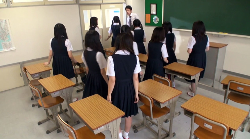 女子生徒10人と男性教師が教室で会話する